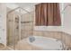 Beautiful bathroom featuring a glass shower and a separate soaking tub at 11917 Greenchop Pl, Riverview, FL 33579