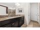 Bathroom featuring a double vanity with dark cabinets and granite countertops at 11917 Greenchop Pl, Riverview, FL 33579