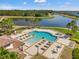Aerial view of the community pool with ample lounge seating and views of the lake at 11917 Greenchop Pl, Riverview, FL 33579