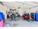 Spacious two-car garage featuring exercise equipment and lawn mower at 11917 Greenchop Pl, Riverview, FL 33579