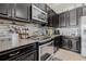 Modern kitchen details include tile backsplash, stainless appliances, and granite countertops at 11917 Greenchop Pl, Riverview, FL 33579