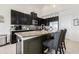 Modern kitchen with granite counters, stainless steel appliances, and dark wood cabinets at 11917 Greenchop Pl, Riverview, FL 33579