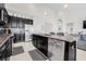 Modern kitchen with granite counters, stainless steel appliances, and dark wood cabinets at 11917 Greenchop Pl, Riverview, FL 33579