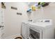 Bright laundry room with modern washer and dryer, shelving and decor at 11917 Greenchop Pl, Riverview, FL 33579