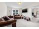 Inviting living room offers comfortable seating, television, and view to the bedroom at 11917 Greenchop Pl, Riverview, FL 33579
