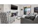 Comfortable living room features a large TV and sliding doors to a lake view at 11917 Greenchop Pl, Riverview, FL 33579