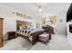 Cozy main bedroom with a king-sized bed, wood furniture, and soft carpet at 11917 Greenchop Pl, Riverview, FL 33579