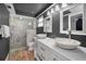 Modern bathroom features double sinks with stylish fixtures and a walk-in shower with glass enclosure at 1212 Royal Oak Dr, Dunedin, FL 34698