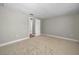 Spacious empty bedroom with neutral walls and plush carpeting at 1212 Royal Oak Dr, Dunedin, FL 34698