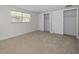 Well-lit bedroom with neutral carpeting and sliding closet doors for ample storage at 1212 Royal Oak Dr, Dunedin, FL 34698