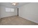 Bright bedroom with a window and neutral carpet at 1212 Royal Oak Dr, Dunedin, FL 34698