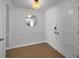 Inviting entryway featuring a round mirror, wood floors and a classic white door at 1212 Royal Oak Dr, Dunedin, FL 34698