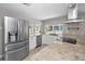 Modern kitchen with stainless steel appliances, granite countertops, white cabinets, and a window over the sink at 1212 Royal Oak Dr, Dunedin, FL 34698