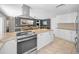 Open kitchen with stainless steel appliances and view of dining area at 1212 Royal Oak Dr, Dunedin, FL 34698