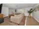 Living room with tan sofa, area rug, and light-colored wood flooring at 1212 Royal Oak Dr, Dunedin, FL 34698