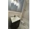 Bathroom featuring a marble sink, white tile, and modern fixtures at 12349 Wasatch Ct, New Port Richey, FL 34654
