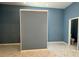 Bright bathroom featuring tile floor and blue walls at 12349 Wasatch Ct, New Port Richey, FL 34654