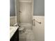 Bathroom featuring a marble sink, white tile, and modern fixtures at 12349 Wasatch Ct, New Port Richey, FL 34654