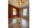 Cozy bedroom featuring hardwood floors, two windows, and a ceiling fan at 12349 Wasatch Ct, New Port Richey, FL 34654