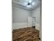 Cozy bedroom with modern lighting, contrasting trim, and wood-look flooring at 12349 Wasatch Ct, New Port Richey, FL 34654