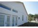 Exterior side view of house with windows and doors at 12349 Wasatch Ct, New Port Richey, FL 34654
