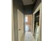 Hallway with tile floors that leads to the bedroom and closet at 12349 Wasatch Ct, New Port Richey, FL 34654