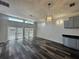 Living room features wood floors, doors to outside and lots of natural light at 12349 Wasatch Ct, New Port Richey, FL 34654
