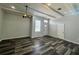 Bright living room featuring modern floors, trim detail, a ceiling fan, and plenty of natural light at 12349 Wasatch Ct, New Port Richey, FL 34654