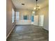 Cozy living room offers wood floors, light from a window, and views of another room at 12349 Wasatch Ct, New Port Richey, FL 34654