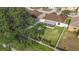 A large backyard with healthy green grass is surrounded by a white fence and mature trees at 12426 Dawn Vista Dr, Riverview, FL 33578