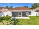 Back exterior view of screened patio and backyard at 12426 Dawn Vista Dr, Riverview, FL 33578