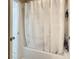 Bathroom features a bathtub with a white shower curtain and tiled walls at 12426 Dawn Vista Dr, Riverview, FL 33578