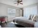 Comfortable bedroom with ceiling fan, plush carpeting and large window for natural light at 12426 Dawn Vista Dr, Riverview, FL 33578