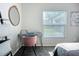 Bright bedroom with a desk, mirror, and large window offering natural light, perfect for a home office at 12426 Dawn Vista Dr, Riverview, FL 33578