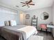 Cozy bedroom with ceiling fan, decorative shelving, writing desk and plush carpeting at 12426 Dawn Vista Dr, Riverview, FL 33578