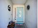 Inviting entryway showcasing stylish decor, including a blue door and beach-themed accents at 12426 Dawn Vista Dr, Riverview, FL 33578