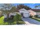 Charming single-story home featuring a well-manicured lawn, screened entry, and attached garage at 12426 Dawn Vista Dr, Riverview, FL 33578