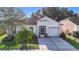 Charming single-story home featuring a well-manicured lawn, screened entry, and attached garage at 12426 Dawn Vista Dr, Riverview, FL 33578
