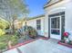 Inviting front porch with decorative plants, landscaping, and a view of the home's exterior at 12426 Dawn Vista Dr, Riverview, FL 33578