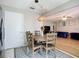 Breakfast nook area with a pendant light above a wooden round table, next to stainless steel refrigerator at 12426 Dawn Vista Dr, Riverview, FL 33578