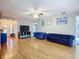 Spacious living room with hardwood floors featuring elegant blue couches and an open floor plan at 12426 Dawn Vista Dr, Riverview, FL 33578