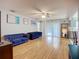 Spacious living room featuring wood floors, stylish blue couches, and bright natural light at 12426 Dawn Vista Dr, Riverview, FL 33578