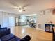 Inviting living room featuring hardwood floors, a ceiling fan, and an open floor plan to the kitchen at 12426 Dawn Vista Dr, Riverview, FL 33578