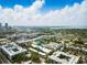 Property aerial with locator shows proximity to downtown and the bay, set against a backdrop of blue skies and clouds at 1316 W Carmen St # 2, Tampa, FL 33606