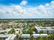 Aerial view shows prime location near a park, within a vibrant neighborhood, and a backdrop of a sunny, expansive sky at 1316 W Carmen St # 2, Tampa, FL 33606
