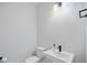 Minimalist powder room with pedestal sink, modern fixtures, and clean lines at 1316 W Carmen St # 2, Tampa, FL 33606