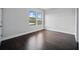 A bright bedroom showcases hardwood floors, ample natural light through the double windows, and neutral colored walls at 1316 W Carmen St # 2, Tampa, FL 33606