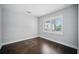 Bedroom with dark hardwood floors, neutral walls, and a window featuring white shutters for ample sunlight at 1316 W Carmen St # 2, Tampa, FL 33606