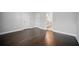 Large empty room with hardwood floors, multiple doors, and ample space, ready for personalization at 1316 W Carmen St # 2, Tampa, FL 33606