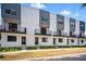 Modern townhome exterior showcasing balconies, clean lines, and individual entryways at 1316 W Carmen St # 2, Tampa, FL 33606